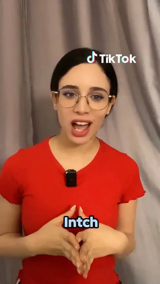 Frame from a TikTok video in which a creator in a red top talks about the Intch app.