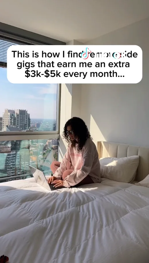TikTok video frame of a woman working on a laptop with a caption about how she finds remote side gigs earning an extra $3k-$5k a month.