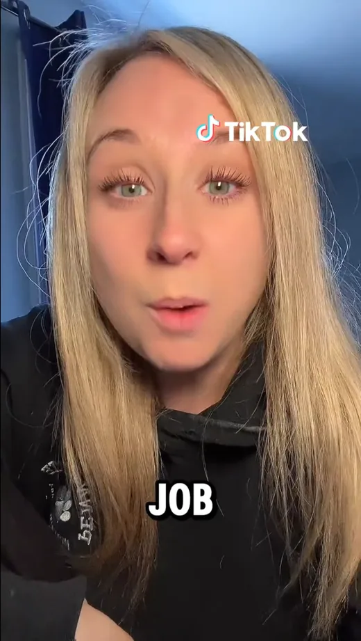 Frame from a TikTok video in which a creator talks to the camera about finding a job, with the on-screen caption "JOB".